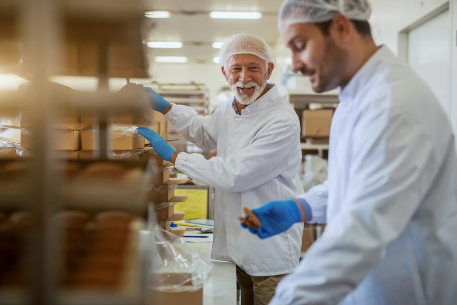 Operarios en una planta alimentaria realizando tareas de control y producción